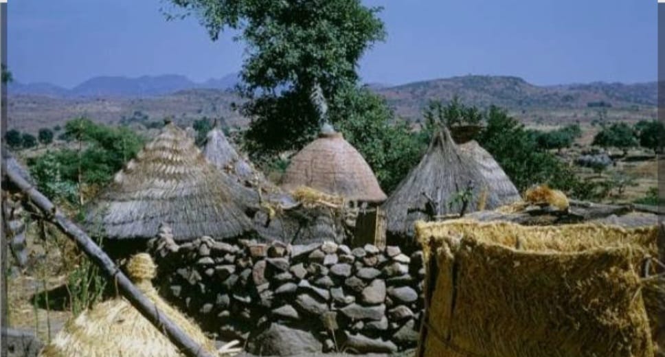 Gude village compound with mountain backdrop